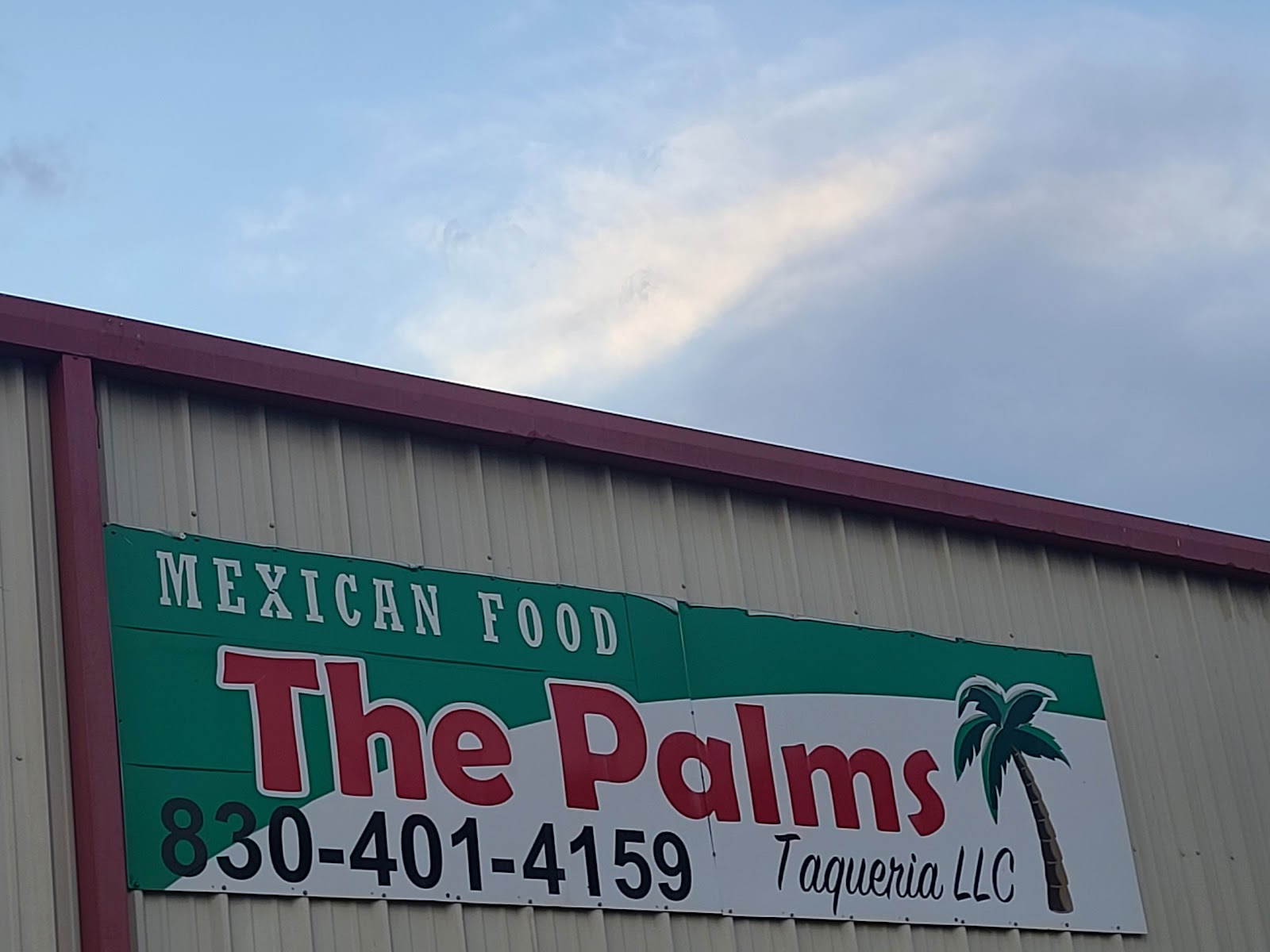 Close up of The Palms Taqueria Mexican Food storefront sign